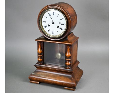 A Victorian mahogany drum cased mantel clock, the eight day two train movement striking on a bell, over an glazed-in drop pen