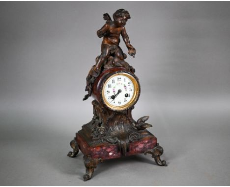 An antique French rouge marble spelter mounted mantel clock, the 8-day two train movement by Moulin, striking the hours and h