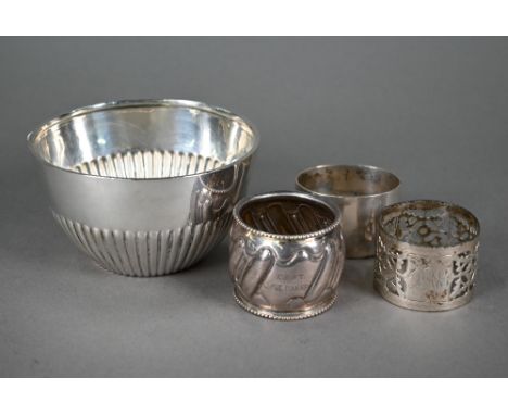 A late Victorian silver half-reeded sugar basin, London 1899 (1903 presentation inscription), to/w three silver napkin rings 