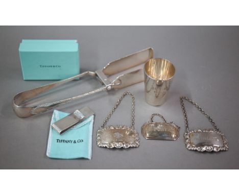 An Edwardian silver pair of pastry/asparagus tongs, London 1902, 4.6oz, to/w a Tiffany &amp; Co sterling money-clip with orig