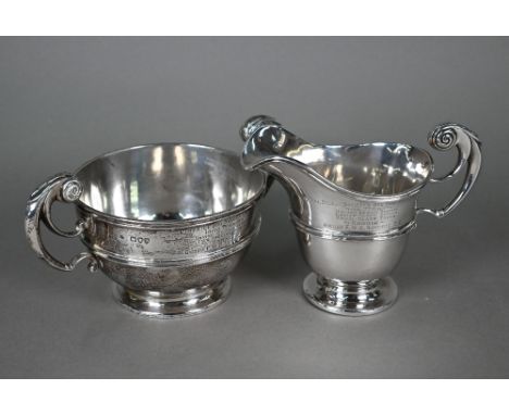 A late Victorian silver milk jug and sugar basin with scroll handles, Goldsmiths and Silversmiths Co., London 1895, 21.8oz; e