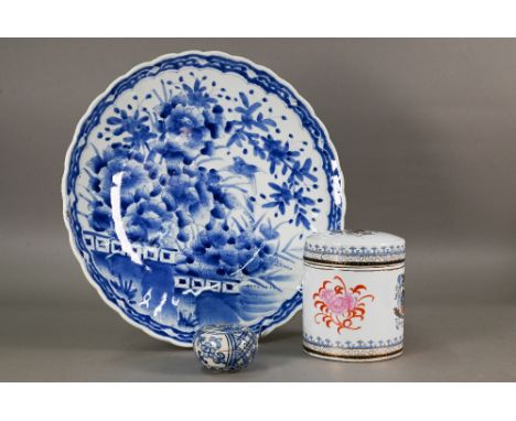 A large 19th century Japanese chrysanthemum form charger painted with a fenced garden landscape and bird, Meiji period (1868-