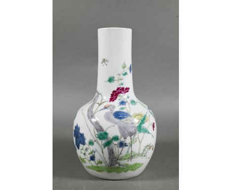 A 19th century Chinese famille rose bottle vase, painted in polychrome enamels with a tall prunus tree, flowering peony and a