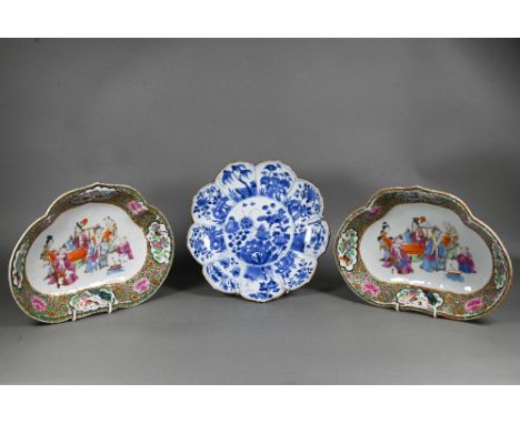A pair of 19th century Chinese famille rose ruyi-shaped dishes, painted in Canton palette polychrome enamels with officials a