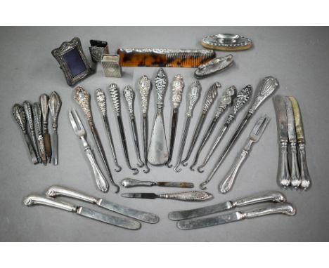 A collection of silver-handled button-hooks, to/w tea knives, nail-buffers, matchbox covers, etc. 