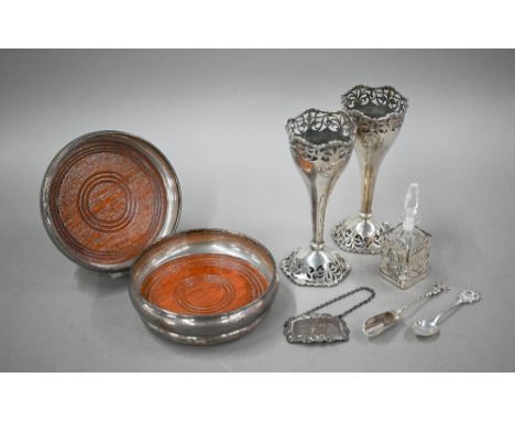 A pair of silver bottle coasters with turned wood bases, Birmingham 1979, to/w a pair of loaded silver vase-flutes with pierc