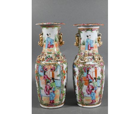 A pair of 19th century Chinese Canton famille rose baluster vases with everted foliate rims, applied with gilded guardian lio