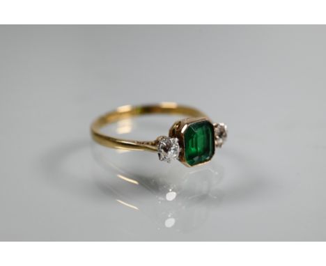 AMENDMENT GREEN STONE&nbsp; An antique green stone and diamond ring, the central rectangular step cut stone in milgrain setti