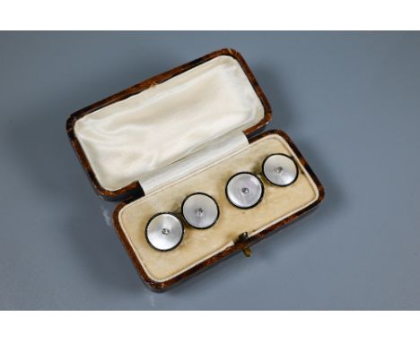 A cased pair of 18ct yellow gold chain-linked cufflinks set mother of pearl with enamel border and diamond to centre 