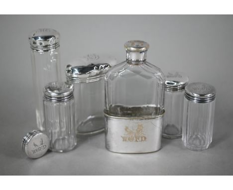 Three cut glass silver-topped toilet jars and a spare lid, London 1892, engraved with initials and crests for the Featherston