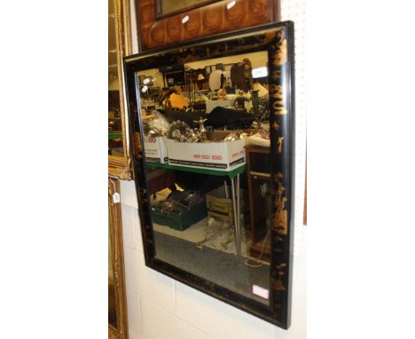 A rectangular wall mirror with a black ground chinoiserie style frame together with a pair of white painted wall light fittin