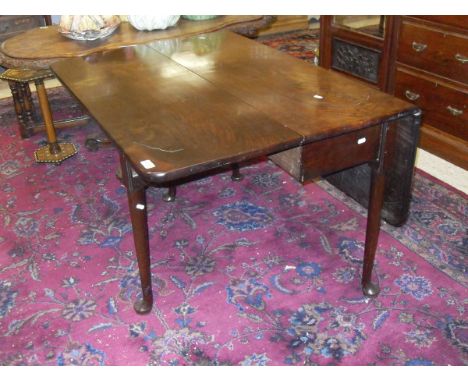 A George II Cuban mahogany drop-leaf dining table, the rectangular top with rounded corners with tapering legs to pad feet   