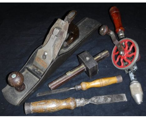 A box of various wood-working tools including a Falcon No. F6 plane, two bit and brace, another drill, various drill bits, ch