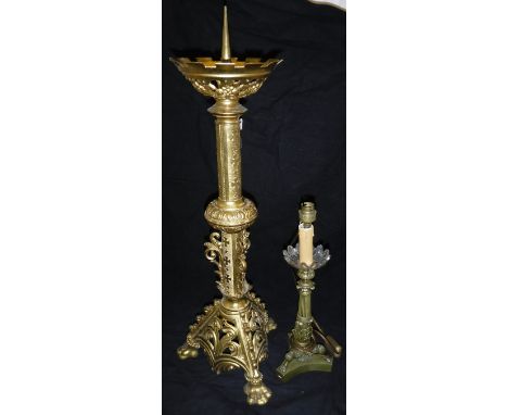 A Gothic style gilt brass pricket candlestick in the Victorian manner and an Empire style candlestick type table lamp