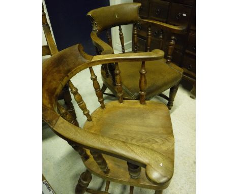 A Victorian smoker's bow chair and a similar upholstered smoker's bow chair
