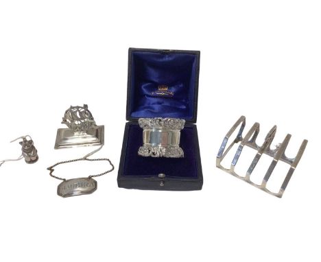 Group of silver, including an Edwardian Mappin &amp; Webb ship-form menu holder, a George V teddy bear, a Victorian Madeira l