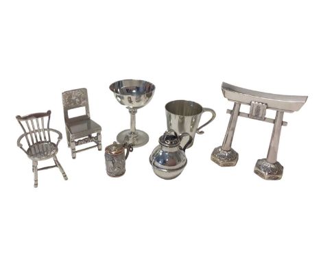 Group of miniature silver items, including a goblet and mug, two chairs, a jug, a tankard marked .900 and a white metal model