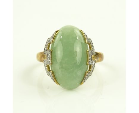 A 9ct gold oval jade set ring with diamond set shoulders, jade height 20mm, size S.