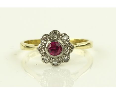 An 18ct ruby and diamond cluster ring, setting 8mm across.