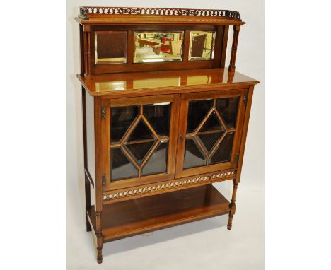 A late Victorian walnut display cabinet with raised mirror panelled shelf back, lattice glazed doors and shelf under, width 3