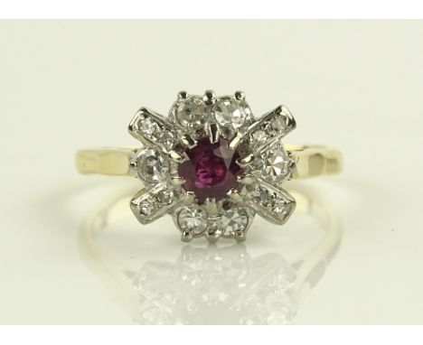 An 18ct gold ruby and diamond cluster ring, setting height 11mm, size R.