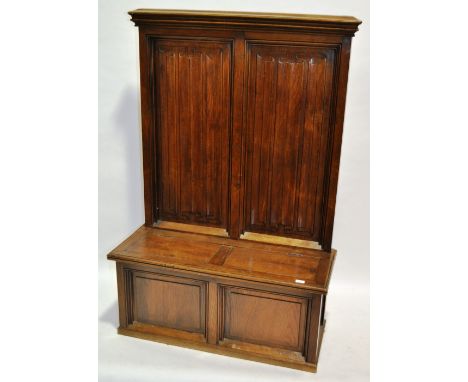 A linen fold carved and panelled oak hall bench, with rising seat and fielded panelled front, width 3'5", height 5'.