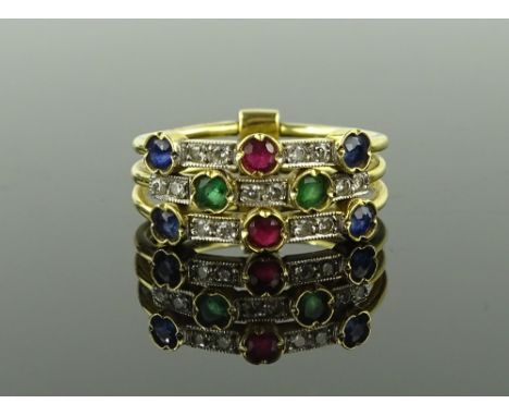 An unmarked gold ruby, emerald, sapphire and diamond set triple band ring, size N.