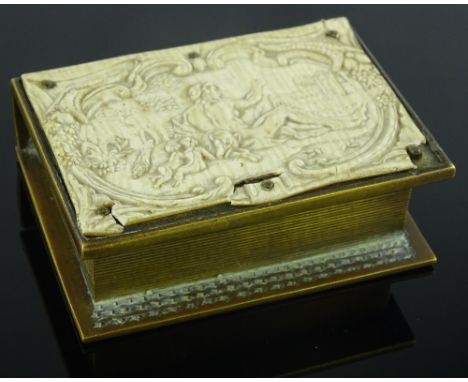 A small brass vesta  box in the form of a book, with composition panel to the lid, length 7cm.