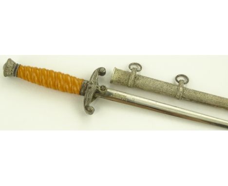 A miniature German Army dagger, yellow composition grip, blade marked Horster, plated scabbard, overall length 20cm.