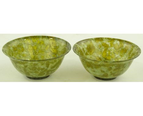A pair of Chinese green jade bowls, diameter 10cm.