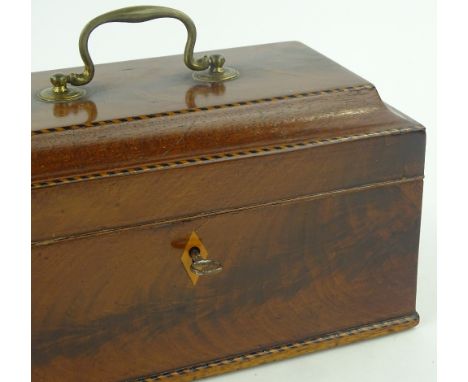 A Georgian mahogany and banded tea caddy with brass handle, length 24cm.