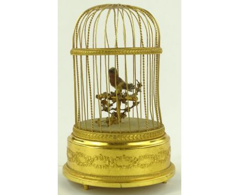A clockwork automaton tweeting bird in gilded case, overall height 25cm, working order.