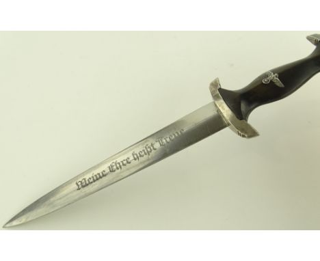 A German Third Reich SS dagger, blade etched with motto, nickel plate hilt with wooden grips and aluminium eagle, original pl