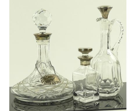 A silver mounted ships decanter with silver label, silver topped claret jug and silver mounted scent bottle, (3).