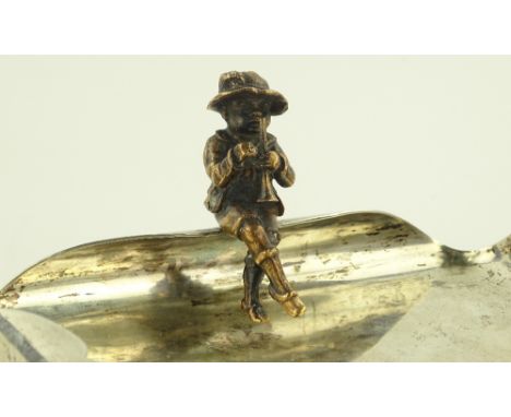A sterling silver dish surmounted by a figure of a child playing a flute, by Ivan Peterson, 13.2 oz, width 15cm.