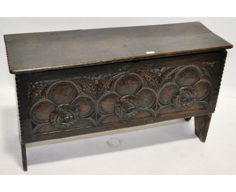 A 17th/18th century oak coffer of plank construction, with relief carved geometric design front panel, length 3'6".