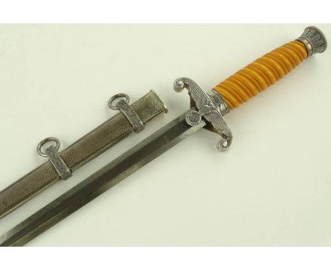 A German Third Reich army dagger, yellow composition grip with plated mounts, blade marked Puma, original plated scabbard.