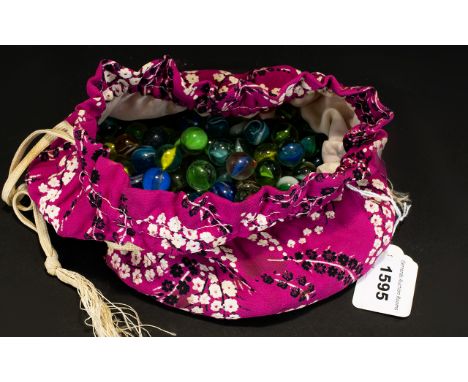 A Collection Of Vintage Glass Marbles Housed in floral printed drawstring pouch, contains various examples. Please see accomp