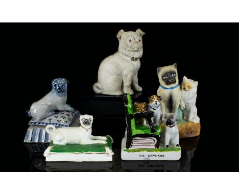 A Collection Of Ceramic Pug Dog Figurines Five in total, mostly late 19th/early 20th century to include a Fairing titled 'The