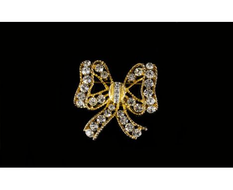 A Vintage Crystal Set Brooch By Eisenberg Gold tone brooch in the form of a bow, the whole set with multiple faceted crystals