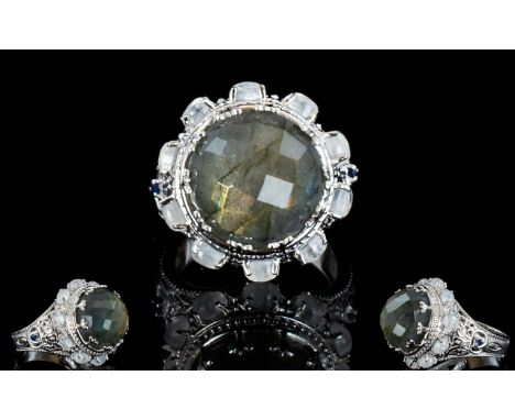 Labradorite and Rainbow Moonstone Statement Ring, with sapphire accents; an 11ct chequerboard faceted, round cut labradorite,