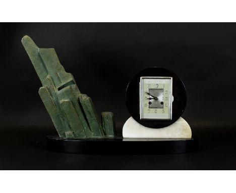 Art Deco Marble And Mixed Metal Mantle Clock Raised on oval black marble base, the clock of typical geometric Art Deco form w