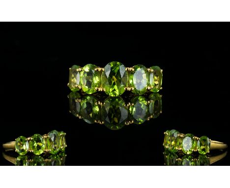 Peridot Five Stone Ring, the five oval cut, graduated peridots centred by one of 2cts, the further four totalling 3.75cts, se