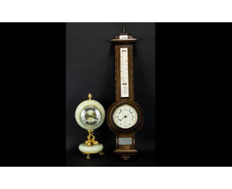 An Oak Cased Barometer with a presentation plaque dated 1930, Height 25 inches. Together with an onyx desk clock, brass mount