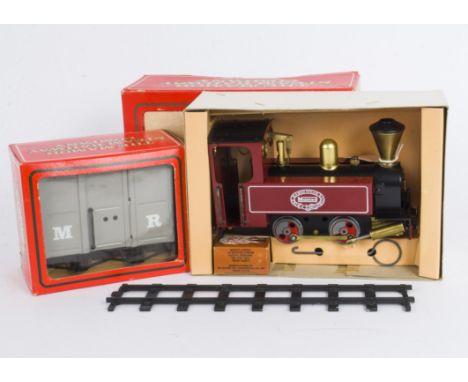 A Mamod 0 Gauge Live Steam 0-4-0 Tank Locomotive Stock and Track, the locomotive model SL3 in maroon with 'Colonial' style ch