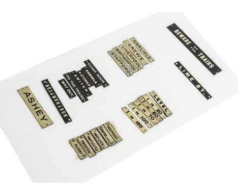 A Collection of Bassett-Lowke 0 Gauge Railway-related Signs, including black-on-white gradient signs and place names includin