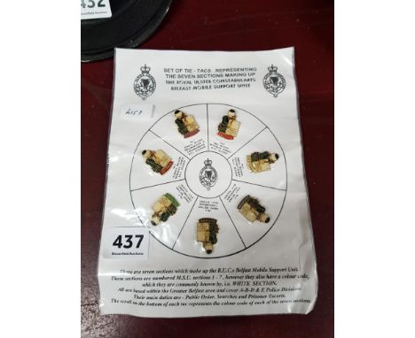 SET OF TIE PINS REPRESENTING THE SEVEN SECTIONS MAKING UP THE ROYAL ULSTER CONSTABULARY'S BELFAST MOBILE SUPPORT UNIT