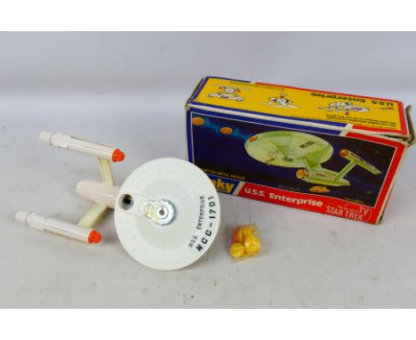Dinky - A boxed diecast #358 U.S.S. Enterprise with shooting discs in a sealed bag. Item appear to be in very good condition.