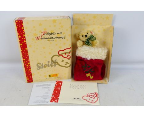 Steiff - A boxed Steiff 'Limited Edition' #037740 'Teddy Bear with Christmas Stocking'. The 14cm high teddy is still attached