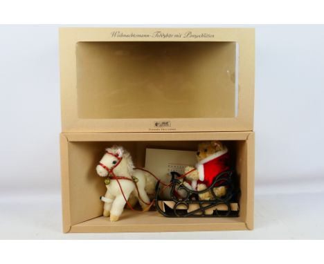 Steiff - A boxed Steiff 'Limited Edition' #670879 'Father Christmas Teddy Bear with Pony Sledge'. Both the bear and pony are 